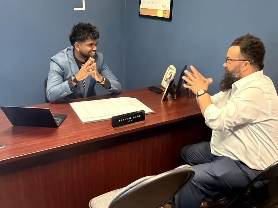 JP meeting with a partner at the office desk