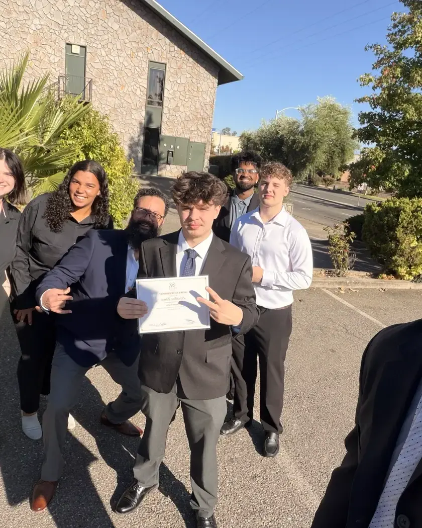 The team outside the office after a promotion